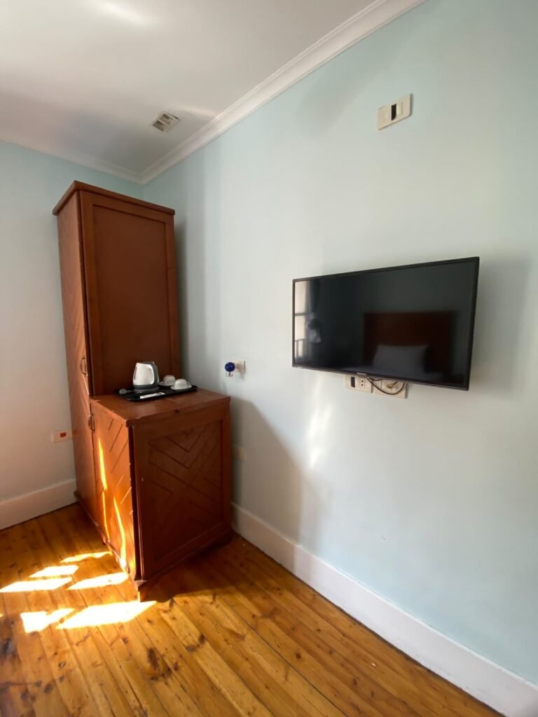 Triple room wall-mounted TV, wardrobe and a kettle tray with cups